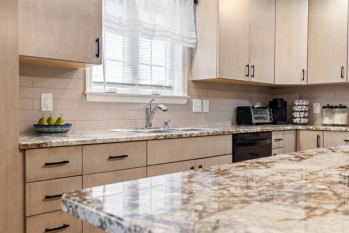 Light maple kitchen perimeter cabinets.