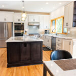 White kitchen with dark stained island and accents.