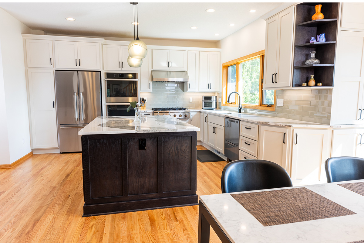 White kitchen with dark stained island and accents.