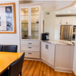 White kitchen with dark stained island and accents.