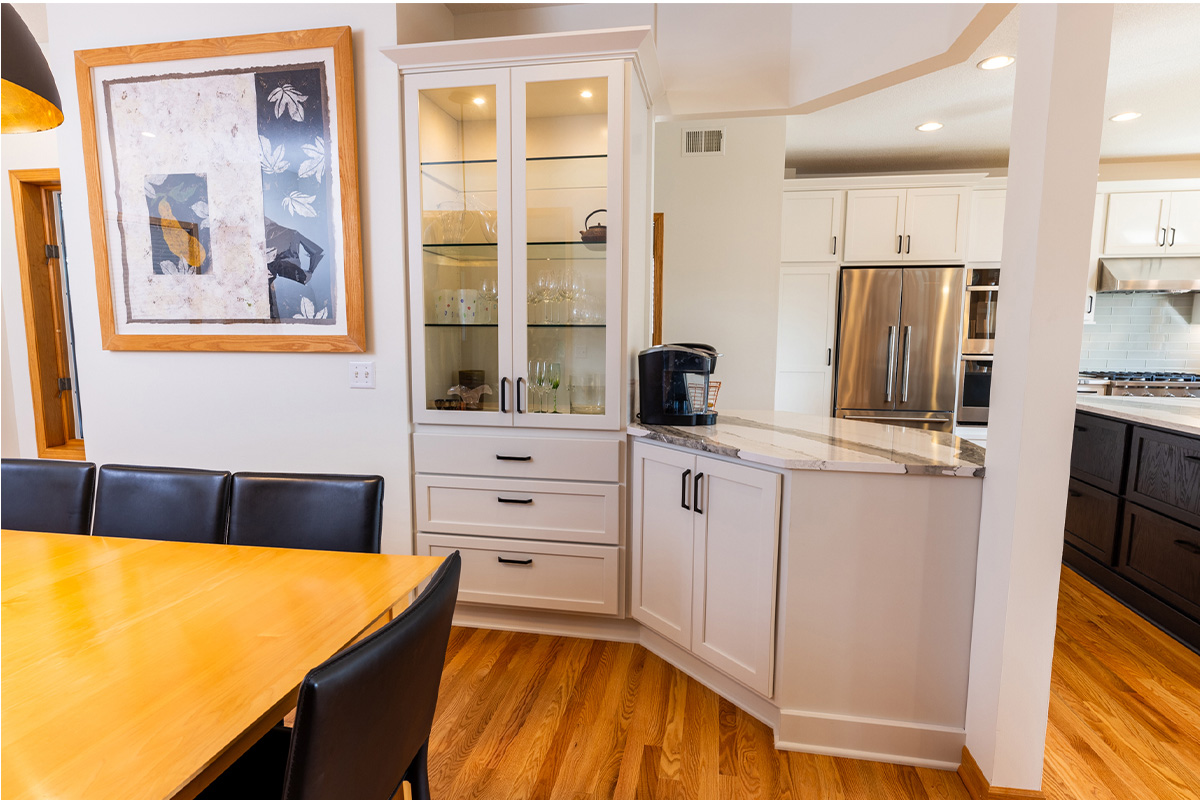 White kitchen with dark stained island and accents.