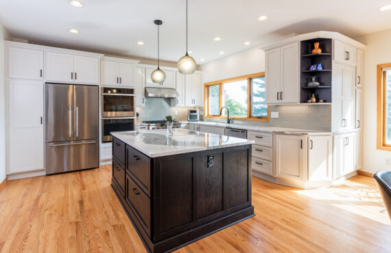 White kitchen with dark stained island and accents.