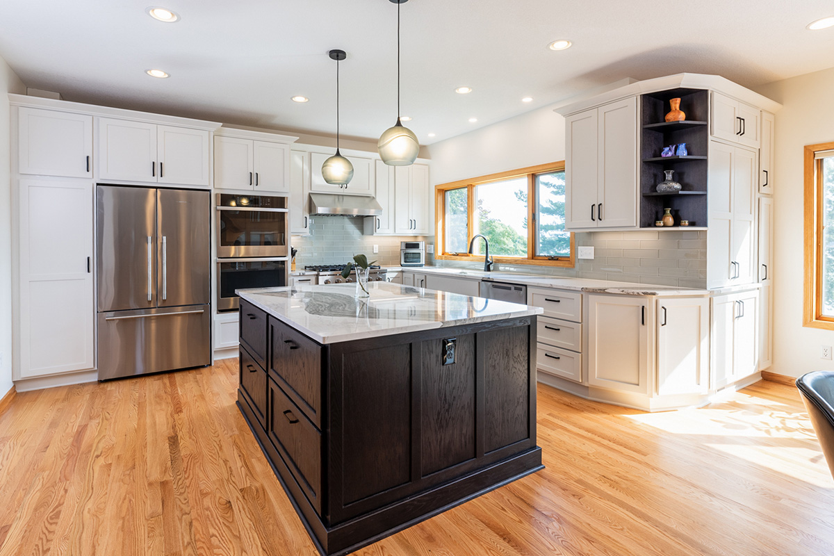 White kitchen with dark stained island and accents.