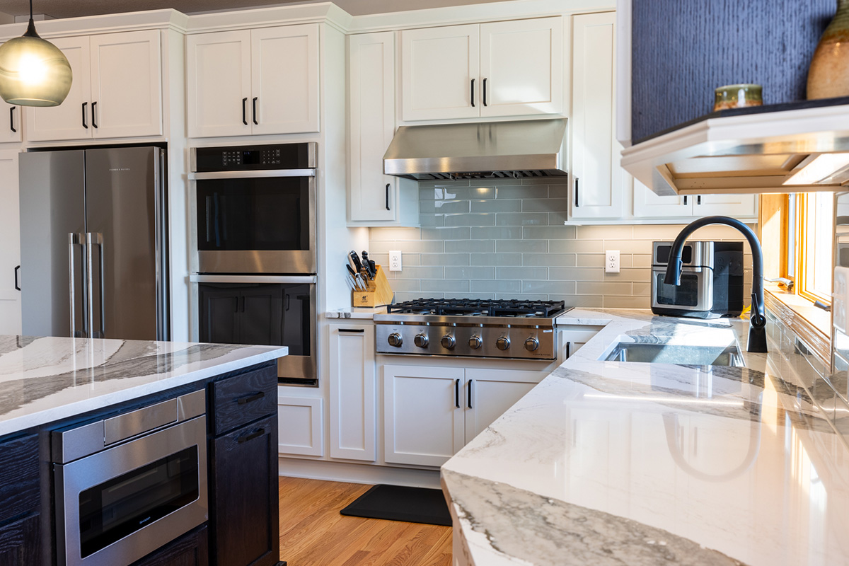 White kitchen with dark stained island and accents.