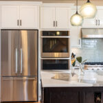 White kitchen with dark stained island and accents.