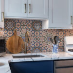 White and blue kitchen cabinets. View of the sink.