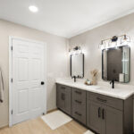 Gray bathroom vanity with 2 sinks and mirrors