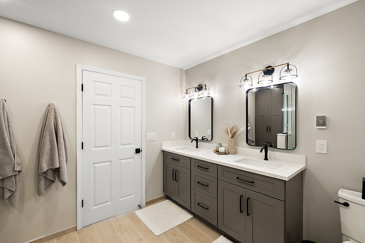 Gray bathroom vanity with 2 sinks and mirrors
