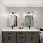 Gray bathroom vanity with 2 sinks and mirrors