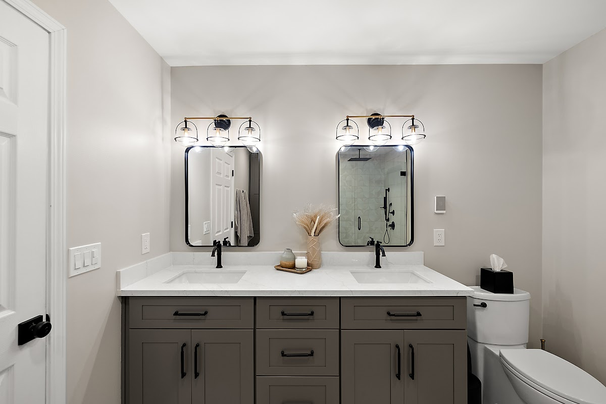 Gray bathroom vanity with 2 sinks and mirrors