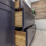 Blue bathroom vanity with drawers open