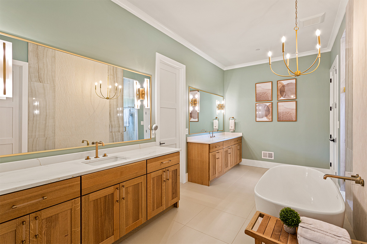 Light stained bathroom vanity cabinets and free standing tub