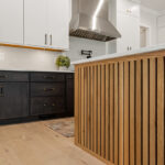 Kitchen with painted white and dark stained cabinetsv