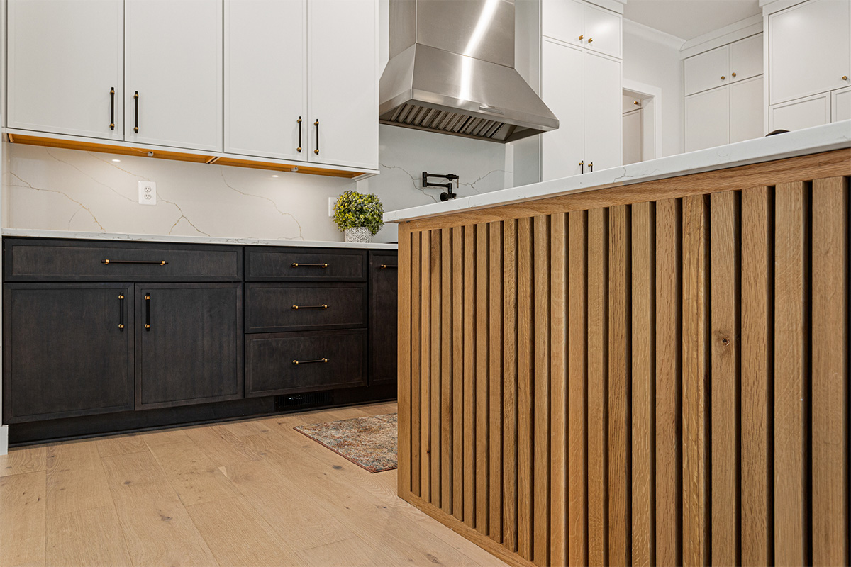 Kitchen with painted white and dark stained cabinetsv