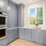 Painted pantry cabinets with double oven.