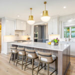 White kitchen cabinets with stained hickory island.