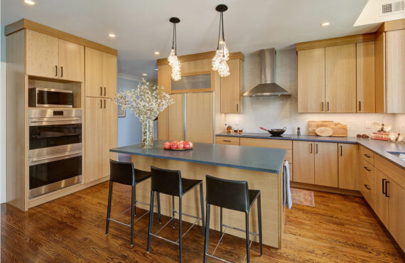 Light brown stained kitchen with island seating.
