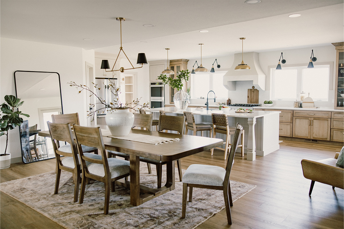 Dining room view into a kitchen with painted island and stained perimeter.