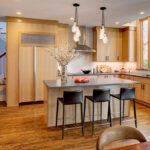 Light brown stained kitchen with island seating.