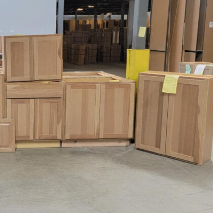 Misc. cabinets in a light brown stain on hickory in a warehouse setting.