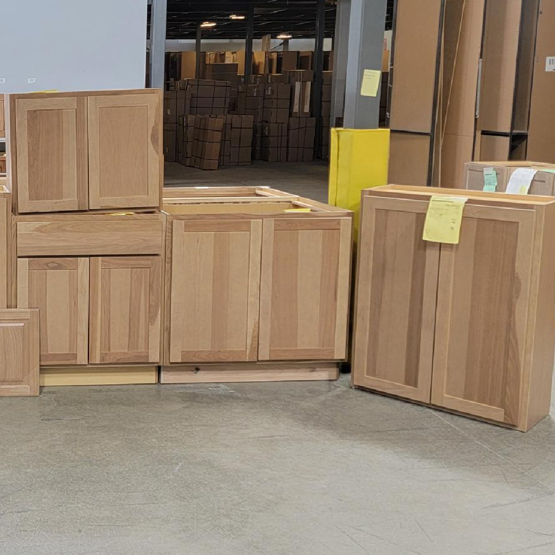 Misc. cabinets in a light brown stain on hickory in a warehouse setting.