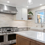 White and Cashew stained kitchen cabinets with long island with seating
