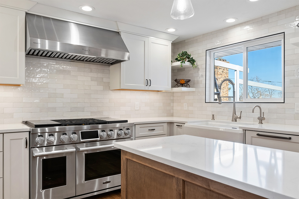 White and Cashew stained kitchen cabinets with long island with seating