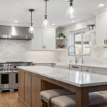 White and Cashew stained kitchen cabinets with long island with seating