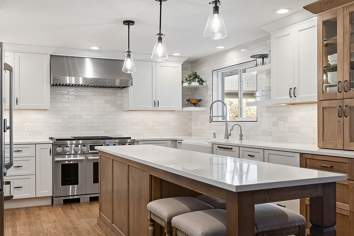 White and Cashew stained kitchen cabinets with long island with seating