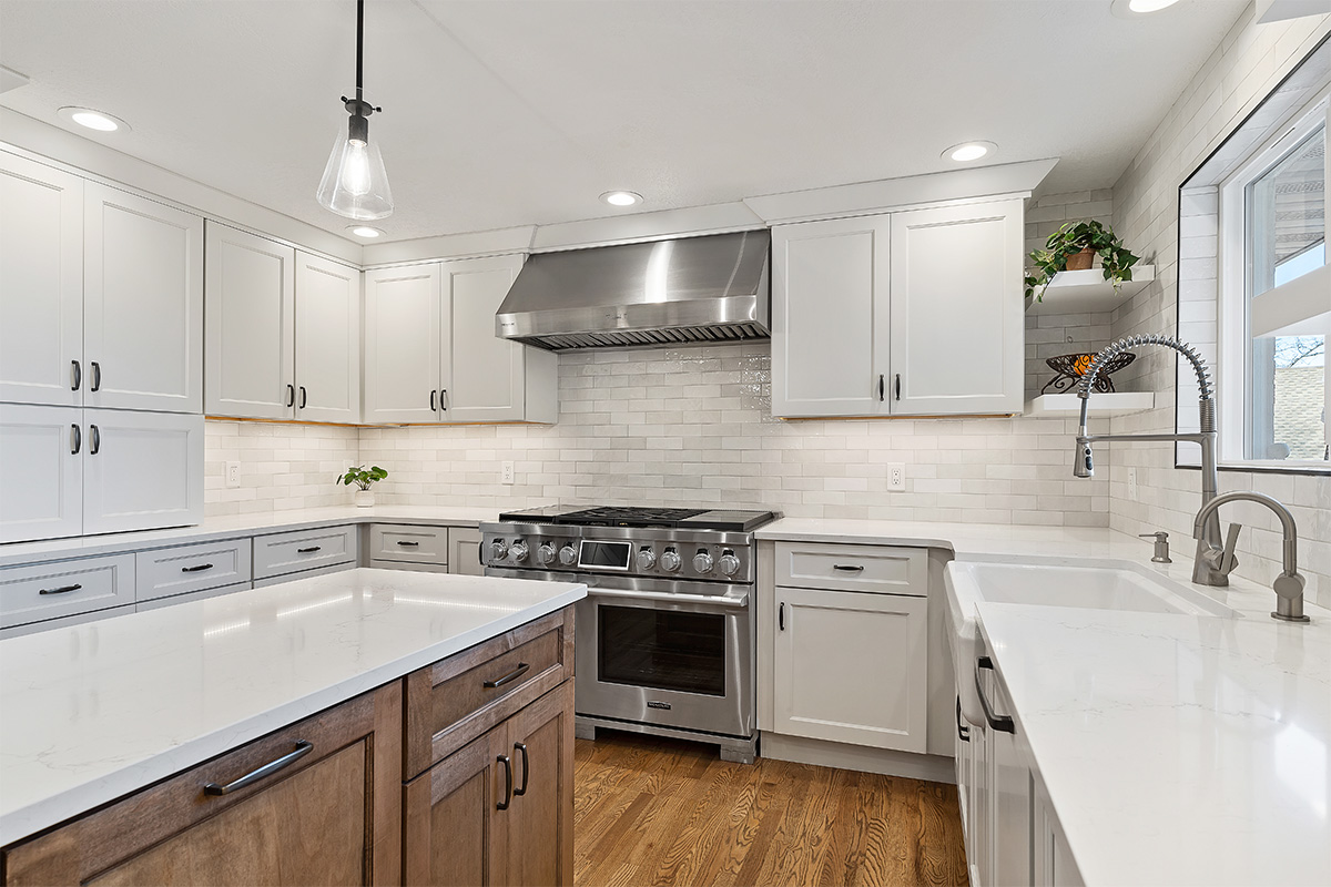 White and Cashew stained kitchen cabinets with long island with seating