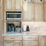 Cashew-stained kitchen perimeter cabinets.