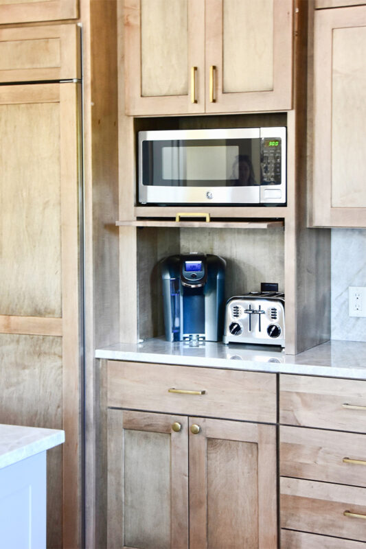 Cashew-stained kitchen cabinets with appliance storage