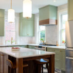 Painted kitchen perimeter cabinerts with walnut island.