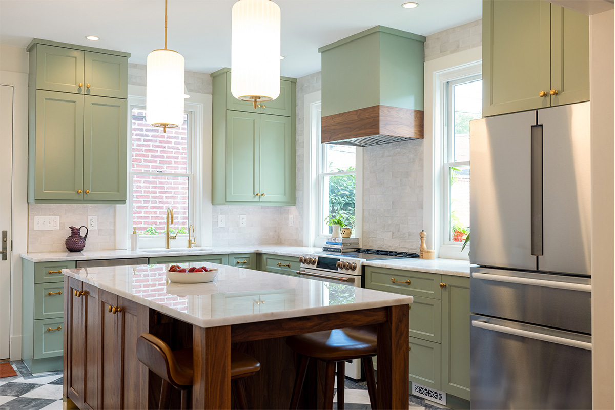 Painted kitchen perimeter cabinerts with walnut island.