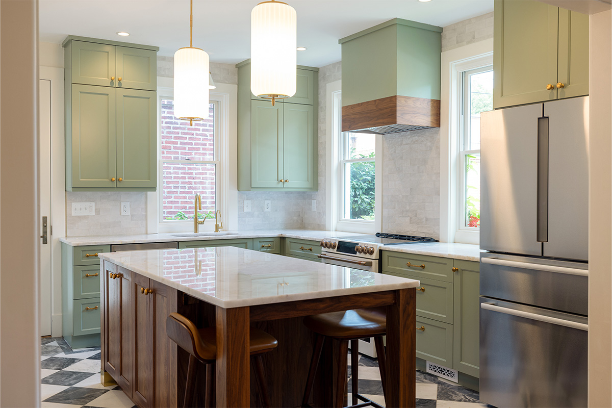 Painted kitchen perimeter cabinerts with walnut island.