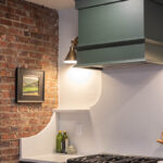 Purple painted wood hood above stove.