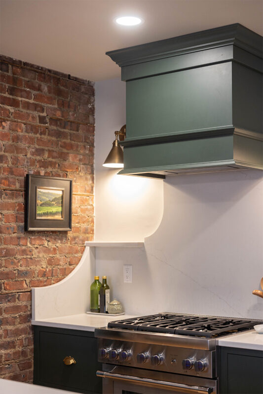 Purple painted wood hood above stove.