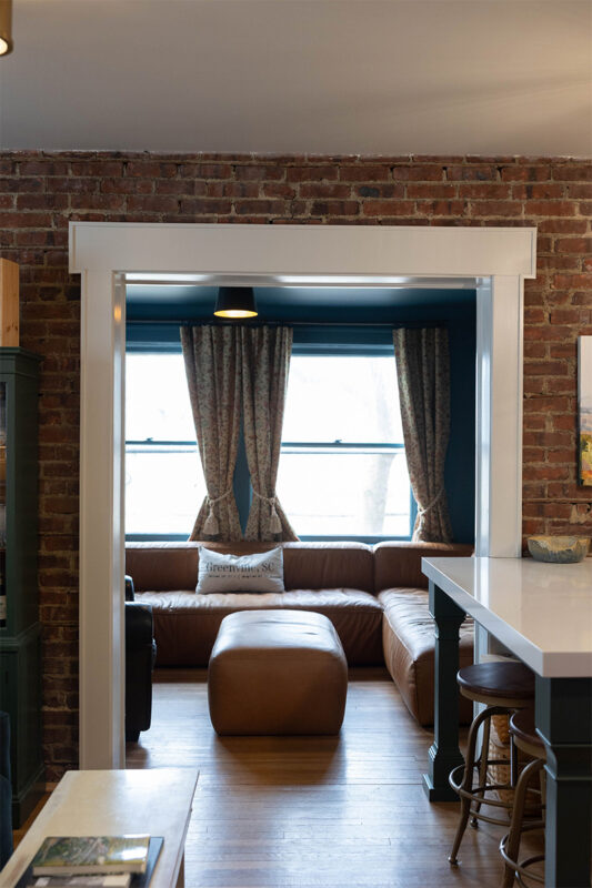 Living room view from the kitchen through an open walkway.