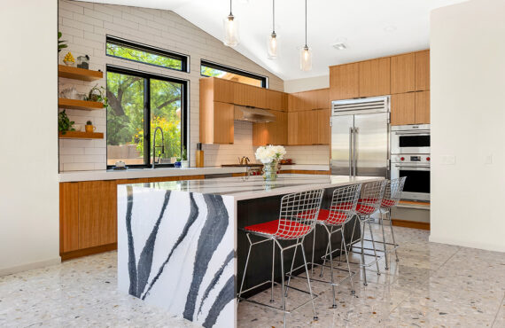 Kitchen with natural cherry perimeter cabinets and dark stained island cabinets.
