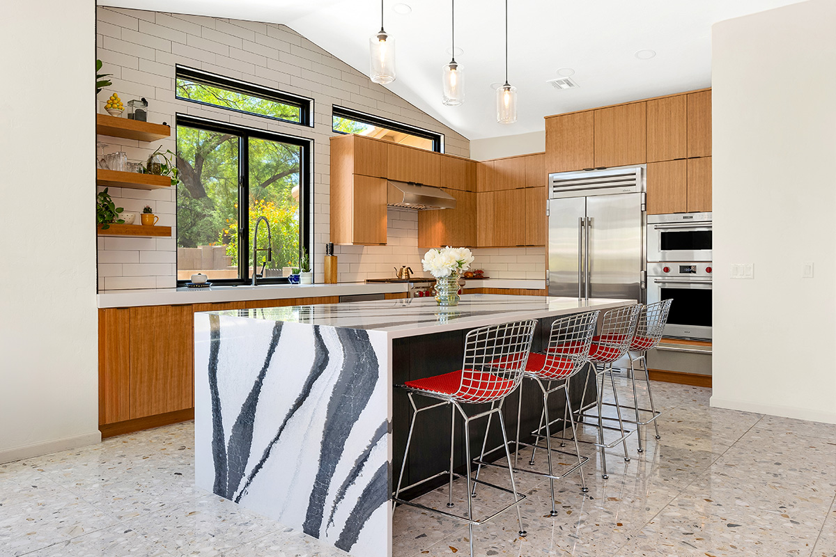 Kitchen with natural cherry perimeter cabinets and dark stained island cabinets.