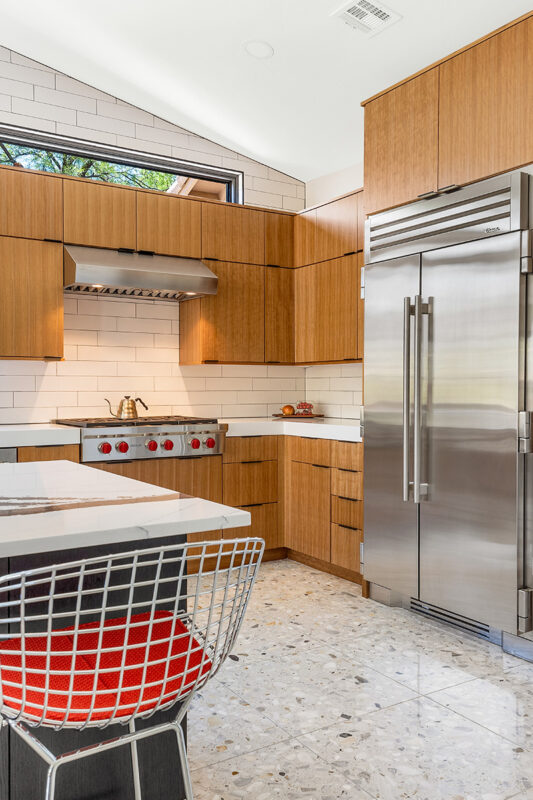 Kitchen with natural cherry perimeter cabinets and dark stained island cabinets.