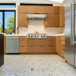Kitchen with natural cherry perimeter cabinets and dark stained island cabinets.