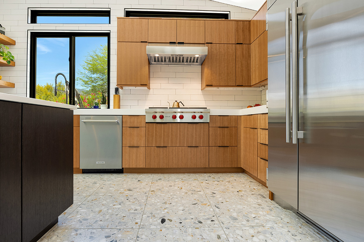 Kitchen with natural cherry perimeter cabinets and dark stained island cabinets.