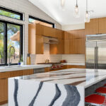 Kitchen with natural cherry perimeter cabinets and dark stained island cabinets.