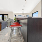 Kitchen with natural cherry perimeter cabinets and dark stained island cabinets.
