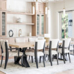 Light stained dining room serving station with table and chairs.