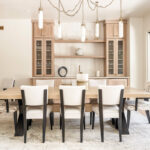 Light stained dining room serving station with table and chairs.