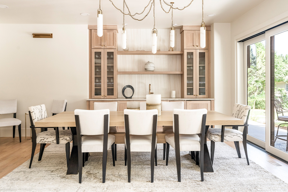 Light stained dining room serving station with table and chairs.