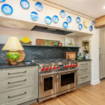 Brown painted kitchen with island and wood beams.