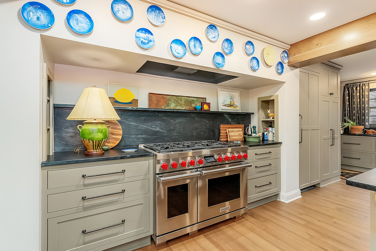 Brown painted kitchen with island and wood beams.